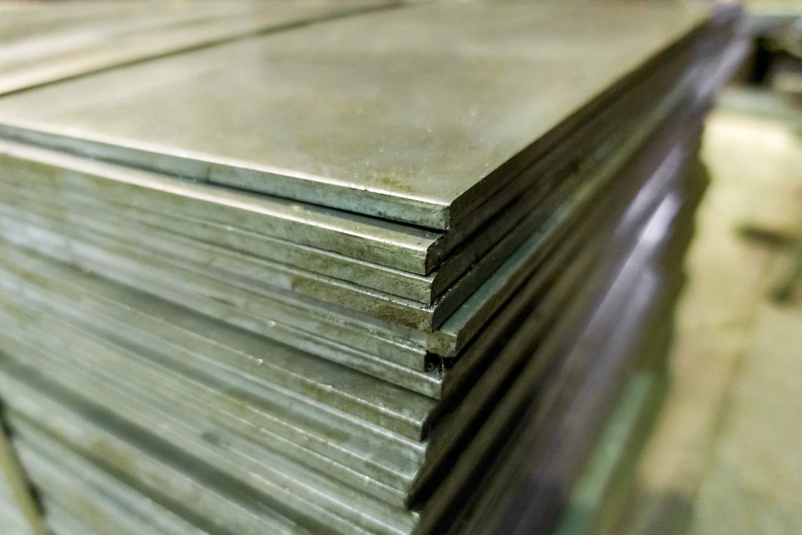 Stack of metal sheets and plates, raw materials for fabrication.