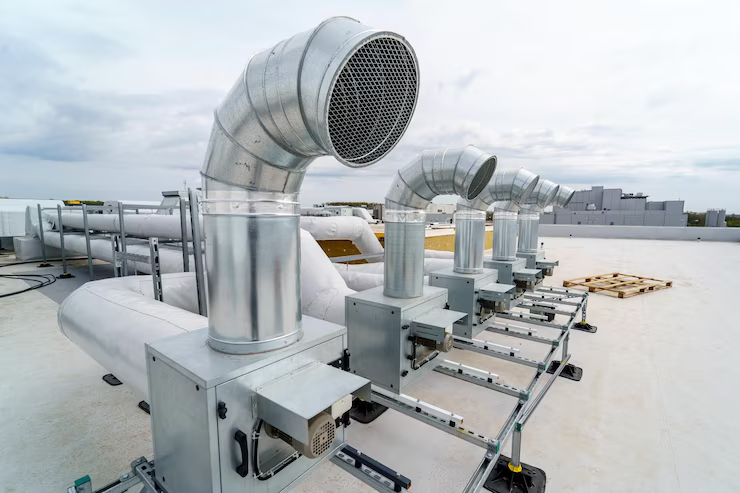 Rooftop HVAC units with stainless steel ductwork, a common installation for commercial buildings.