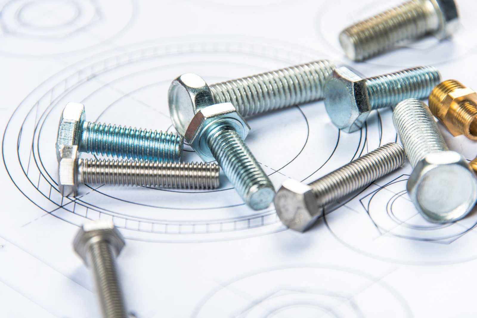 Various bolts and screws on engineering blueprint, related to coils and strips