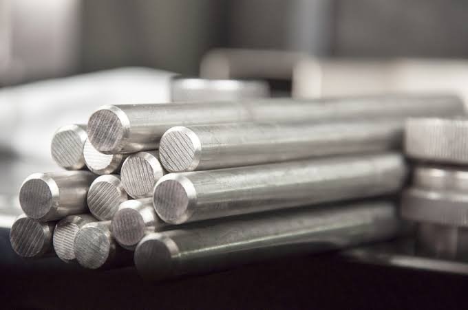 Monel metal rods stacked and ready for industrial use.