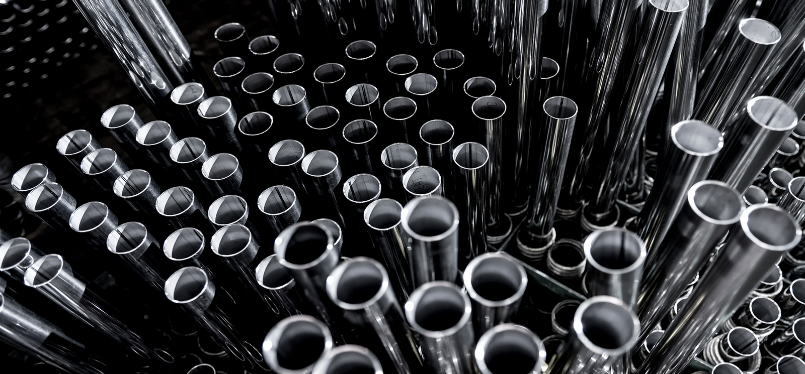 Close-up of shiny metal coils and strips, industrial metal products.